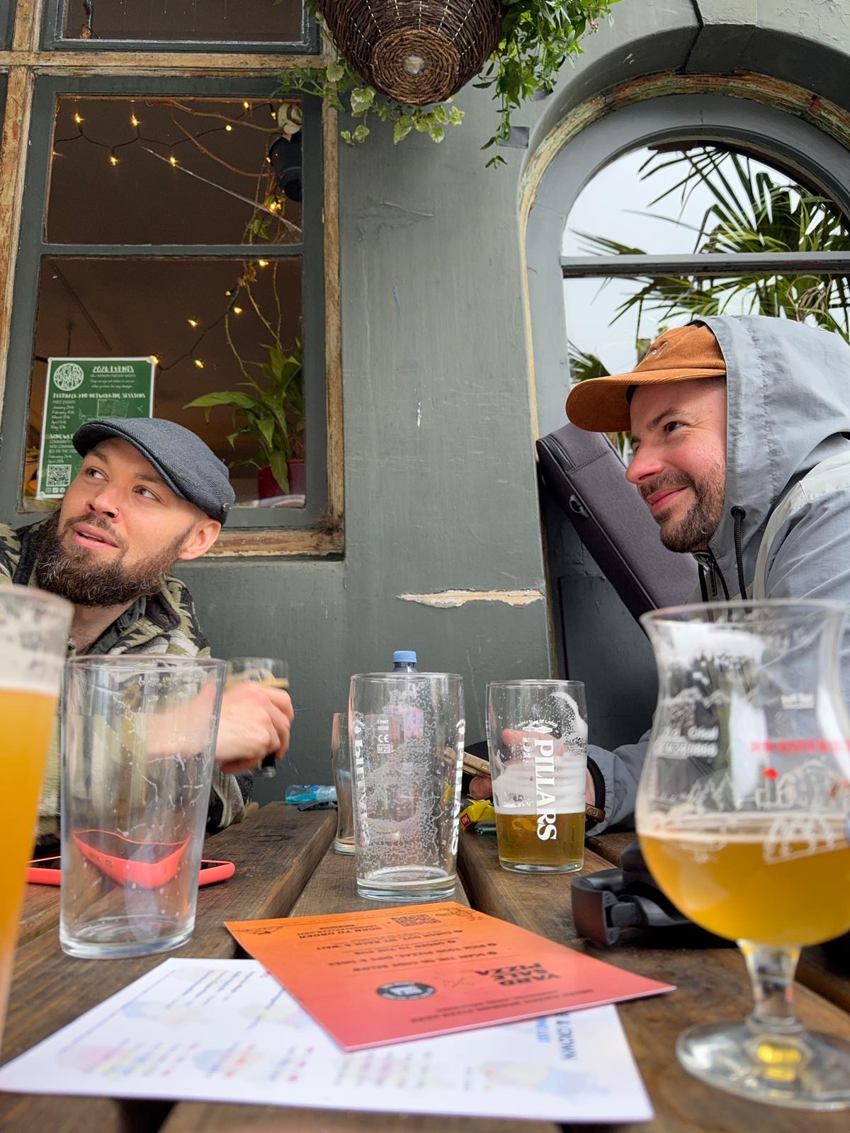 Two band members close up at a pub